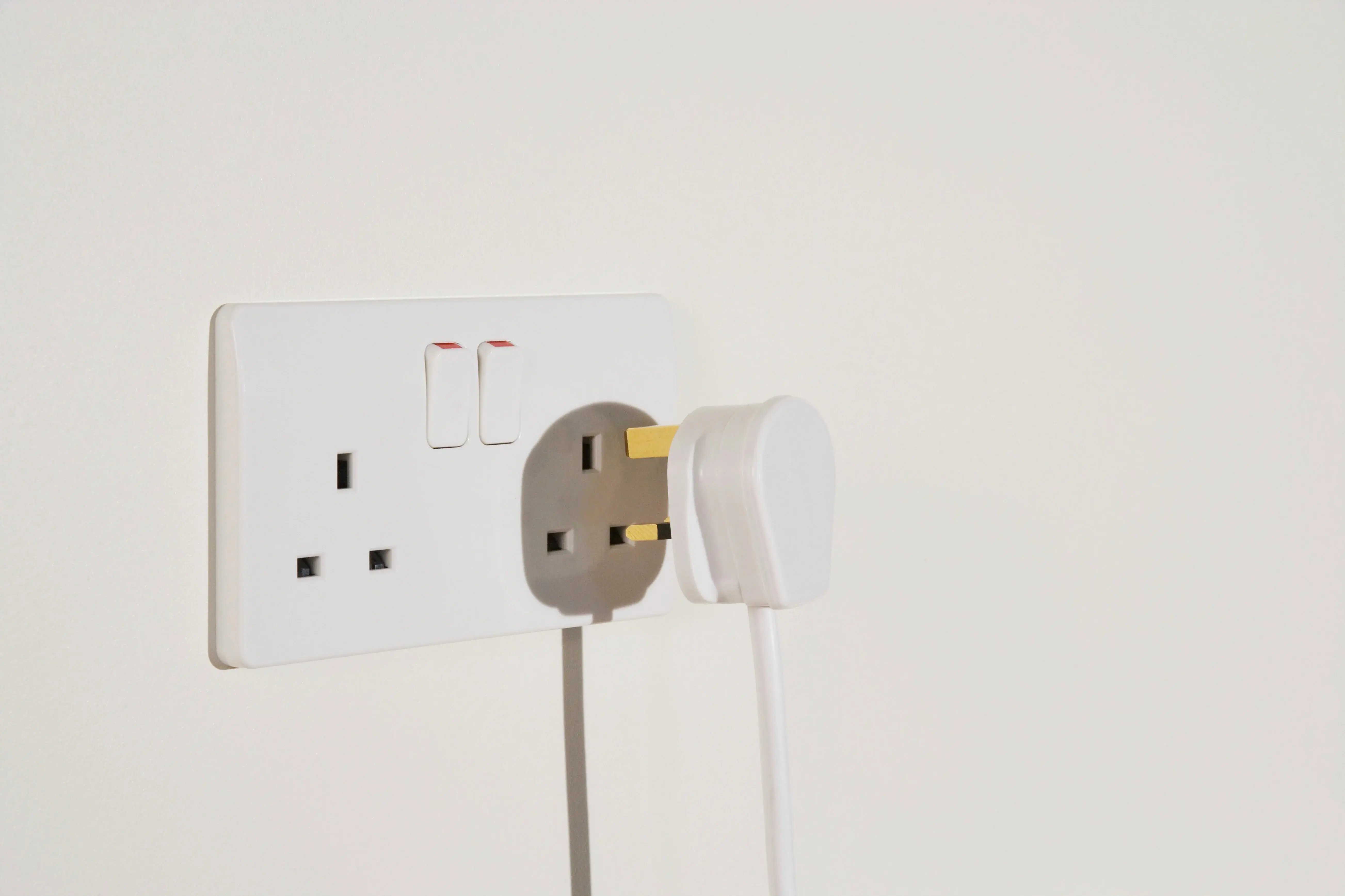 electric-plug-connecting-to-wall-socket-in-home-2026-03-25-05-36-41-utc