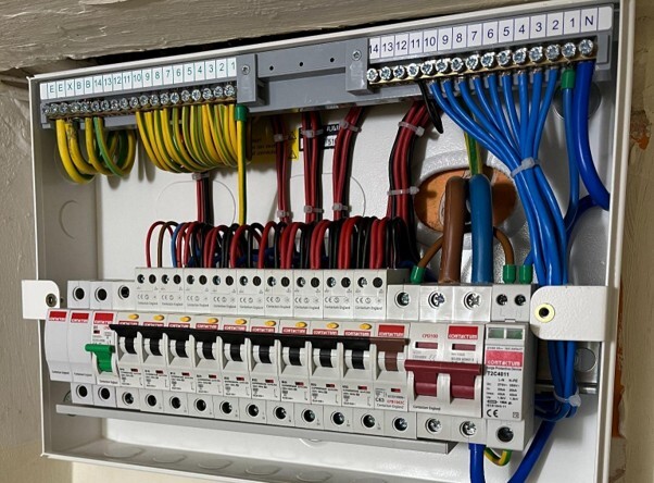 Modern consumer unit with circuit breakers and internal wiring where a fuse box keeps tripping.