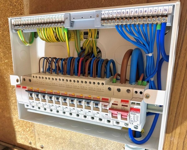 Modern consumer unit showing circuit breakers and internal wiring after replacing a consumer unit.
